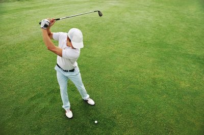 High,Overhead,Angle,View,Of,Golfer,Hitting,Golf,Ball,On